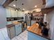 Charming kitchen with stainless steel appliances, butcher block countertops, and ample cabinet space at 1003 W Mahoney St, Plant City, FL 33563