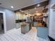 Well-lit kitchen featuring butcher block countertops, an open shelving concept, and stainless steel appliances at 1003 W Mahoney St, Plant City, FL 33563