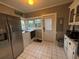 Functional laundry room with washer, dryer, refrigerator, utility sink and storage at 1003 W Mahoney St, Plant City, FL 33563