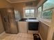 Efficient laundry room with washer, dryer, refrigerator and a window at 1003 W Mahoney St, Plant City, FL 33563
