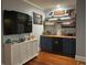 Stylish bar area with striped wallpaper, navy cabinets, wood countertop and a decorative cabinet at 1003 W Mahoney St, Plant City, FL 33563