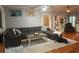 Cozy living room features a sectional sofa, hardwood floors, and a neutral color palette at 1003 W Mahoney St, Plant City, FL 33563