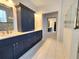 Elegant bathroom with double vanity, large mirror, and walk-in shower at 107 Slipper Key Rd, Apollo Beach, FL 33572