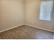 Simple bedroom with wood-look flooring and neutral walls at 107 Slipper Key Rd, Apollo Beach, FL 33572