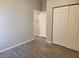 Spacious bedroom with wood-look flooring and ample closet space at 107 Slipper Key Rd, Apollo Beach, FL 33572