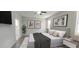 Spacious bedroom with large bed, wood-look floors, and access to bathroom at 107 Slipper Key Rd, Apollo Beach, FL 33572