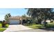 Single-story house with a two-car garage and a landscaped front yard at 107 Slipper Key Rd, Apollo Beach, FL 33572