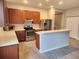 Modern kitchen with stainless steel appliances and breakfast bar at 107 Slipper Key Rd, Apollo Beach, FL 33572