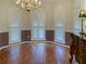 Formal dining room with hardwood floors, crown molding, and plantation shutters at 1135 Candler Rd, Clearwater, FL 33765
