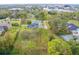 Aerial view showcasing a house, pool, and tennis court at 1135 Candler Rd, Clearwater, FL 33765