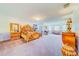 Spacious main bedroom with large bed, dressing area and bay windows at 1135 Candler Rd, Clearwater, FL 33765