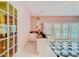 Pink wet bar with black and white checkered floor and pool view at 1135 Candler Rd, Clearwater, FL 33765