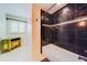 Spacious bathroom featuring dark tile, a soaking tub, and unique vanity at 1135 Candler Rd, Clearwater, FL 33765
