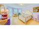 Charming bedroom with pastel purple walls, wood floors, and elegant furniture at 1135 Candler Rd, Clearwater, FL 33765