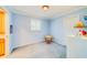 bedroom with blue walls, carpet flooring, and a small table at 1135 Candler Rd, Clearwater, FL 33765
