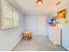 light blue bedroom with gray carpet and a dresser at 1135 Candler Rd, Clearwater, FL 33765