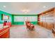 Spacious bonus room with green walls, built-in shelves, and a comfortable recliner at 1135 Candler Rd, Clearwater, FL 33765