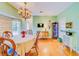 Dining area with chandelier, decorative furniture, and large window with patterned shades at 1135 Candler Rd, Clearwater, FL 33765