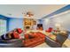 Spacious living room featuring a fireplace, leather furniture, and a large area rug at 1135 Candler Rd, Clearwater, FL 33765
