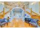 Grand foyer with a dual staircase, hardwood floors, and elegant chandelier at 1135 Candler Rd, Clearwater, FL 33765