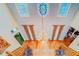 View of the foyer from above, showcasing the dual staircase and stained glass ceiling at 1135 Candler Rd, Clearwater, FL 33765
