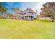 Charming blue two-story home with a large front yard and mature trees at 1135 Candler Rd, Clearwater, FL 33765