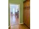 Hallway leading to the dining area with wood floors and wooden cabinetry at 1135 Candler Rd, Clearwater, FL 33765