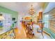 Kitchen and dining area with wood flooring, decorative chandelier, and view of the outdoors at 1135 Candler Rd, Clearwater, FL 33765