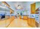 Spacious kitchen with stainless steel appliances, wood cabinets, and granite countertops at 1135 Candler Rd, Clearwater, FL 33765