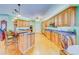 Open kitchen featuring wood cabinetry, granite countertops, and a center island with bar seating at 1135 Candler Rd, Clearwater, FL 33765