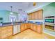 Kitchen features wood cabinets, stainless steel double oven and granite countertops at 1135 Candler Rd, Clearwater, FL 33765