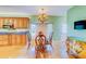 Bright, spacious kitchen with wood cabinetry, granite countertops, and an elegant dining area at 1135 Candler Rd, Clearwater, FL 33765