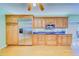 Kitchen with wooden cabinetry, stainless steel appliances, and dark granite counters at 1135 Candler Rd, Clearwater, FL 33765