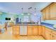 Kitchen with granite counters, light wood cabinets, and stainless steel appliances at 1135 Candler Rd, Clearwater, FL 33765