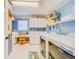 Laundry room with washer, dryer, folding counter, and ample storage at 1135 Candler Rd, Clearwater, FL 33765