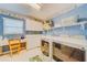 Bright laundry room with white cabinets, washer, dryer, and folding area at 1135 Candler Rd, Clearwater, FL 33765