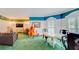 Spacious living room featuring a table, musical instruments, and entertainment center at 1135 Candler Rd, Clearwater, FL 33765