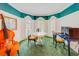 Unique living room with green carpet, bay windows, and musical instruments at 1135 Candler Rd, Clearwater, FL 33765
