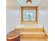 Main bathroom with soaking tub, stained-glass window, and marble tile at 1135 Candler Rd, Clearwater, FL 33765