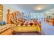 Main bedroom with ornate wooden furniture, patterned bedding, and stained glass window at 1135 Candler Rd, Clearwater, FL 33765