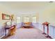 Main bedroom sitting area with vanity, chaise lounge, and ample natural light at 1135 Candler Rd, Clearwater, FL 33765