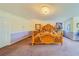 Spacious main bedroom with wooden furniture, plush carpet, and decorative pillows at 1135 Candler Rd, Clearwater, FL 33765