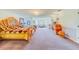 Large main bedroom with ornate bed, sitting area, and unique window at 1135 Candler Rd, Clearwater, FL 33765
