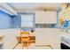 Bright laundry room with built-in cabinets, workspace, and washer/dryer at 1135 Candler Rd, Clearwater, FL 33765