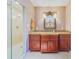Bathroom features granite vanity, custom cabinetry, and a large walk-in shower at 1135 Candler Rd, Clearwater, FL 33765