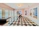 Sunroom with black and white checkered floors, exercise bike, and pool views at 1135 Candler Rd, Clearwater, FL 33765