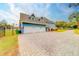 Three-car garage with a paver driveway and side entrance at 1135 Candler Rd, Clearwater, FL 33765
