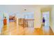 Upstairs hallway with hardwood floors, stained glass window, and view of bedroom at 1135 Candler Rd, Clearwater, FL 33765