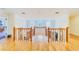 Elegant upstairs hallway with hardwood floors, wooden railing, and stained glass at 1135 Candler Rd, Clearwater, FL 33765