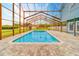 Inviting pool area with a screened enclosure at 1135 Candler Rd, Clearwater, FL 33765